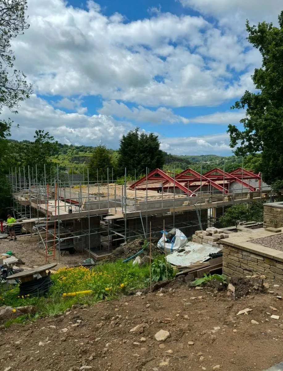 Boarded working platform on a hillside new build