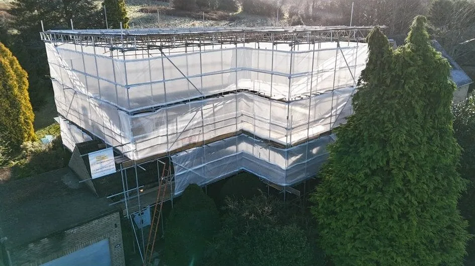 Fully sheeted scaffold around a detached house near Huddersfield